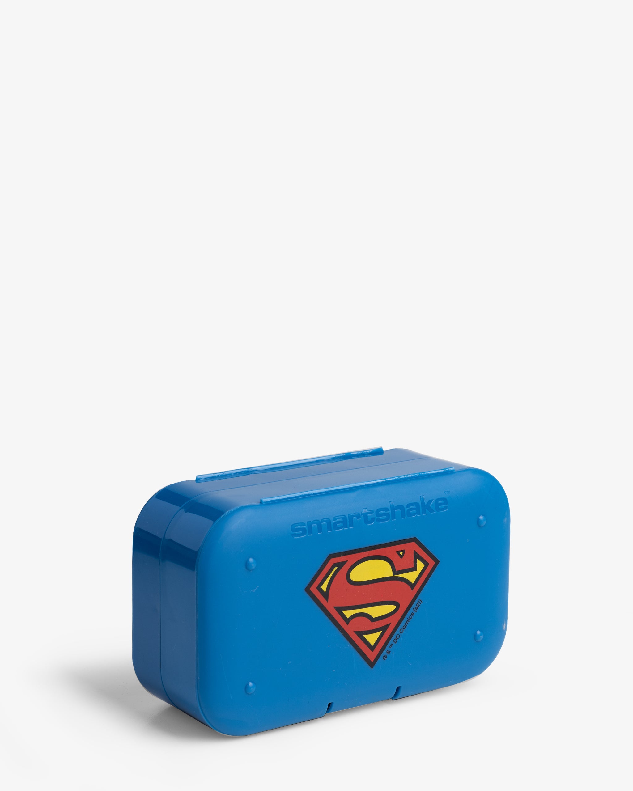 A blue pill box organizer with the Superman logo on the front.