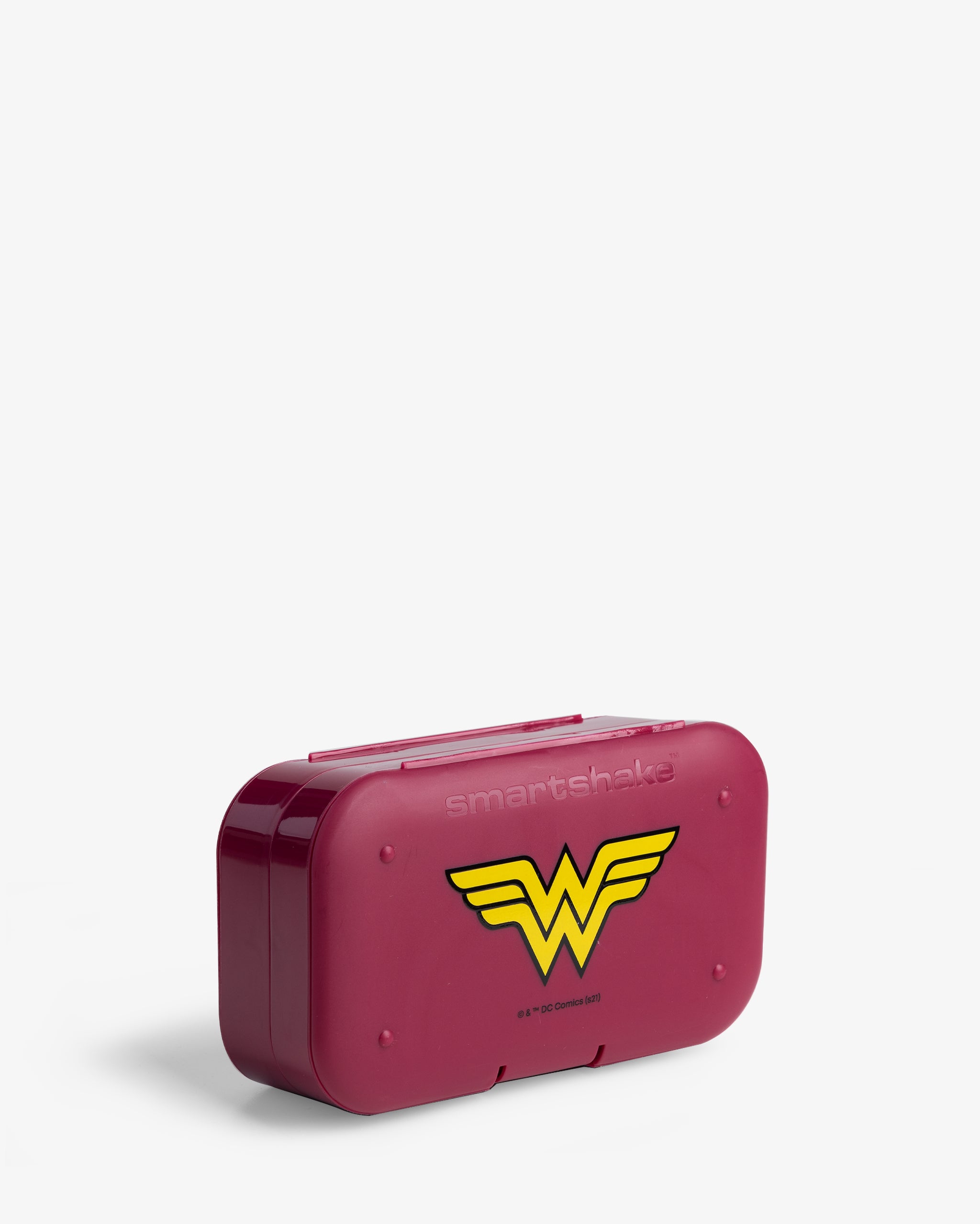 A red pill box organizer with the Wonder Woman logo in yellow and blue.